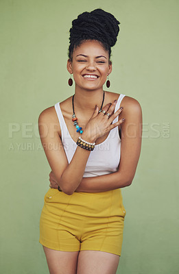 Buy stock photo Fashion, happy and carefree with a model black woman in studio on a green background for trendy style. Laugh, funny and edgy with an attractive young female hipster posing in modern clothes for