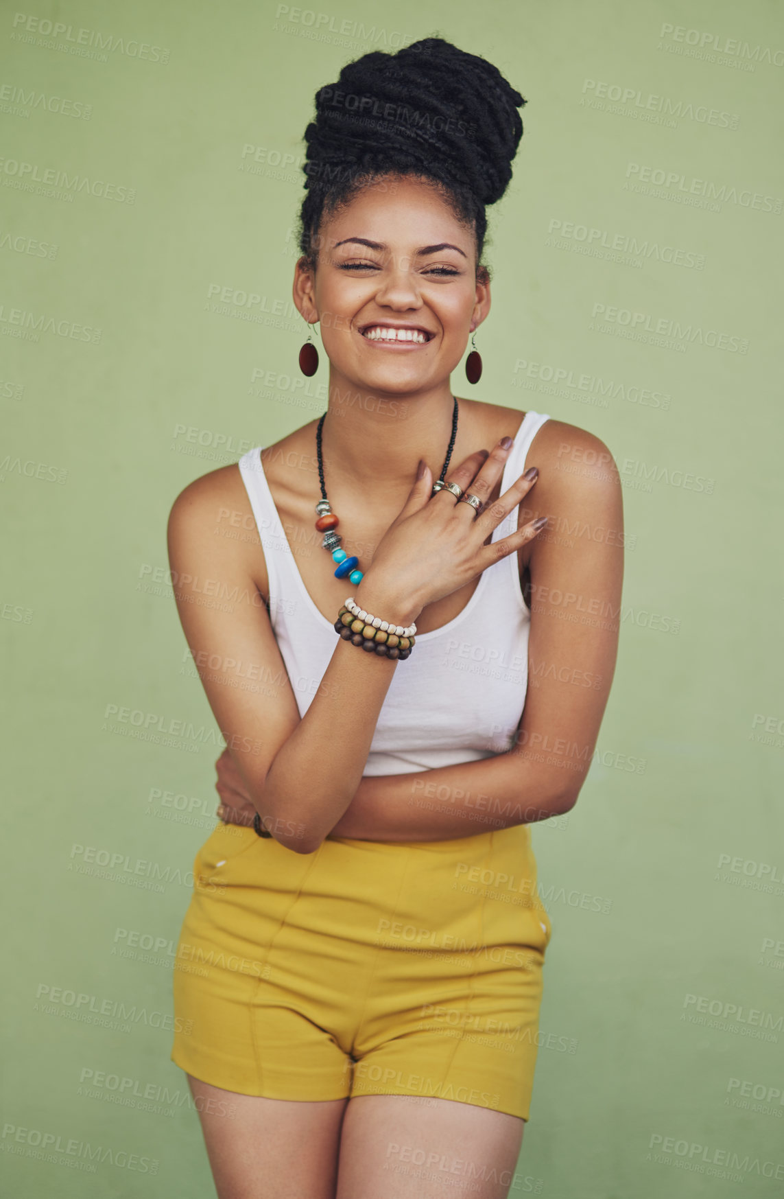 Buy stock photo Fashion, happy and carefree with a model black woman in studio on a green background for trendy style. Laugh, funny and edgy with an attractive young female hipster posing in modern clothes for