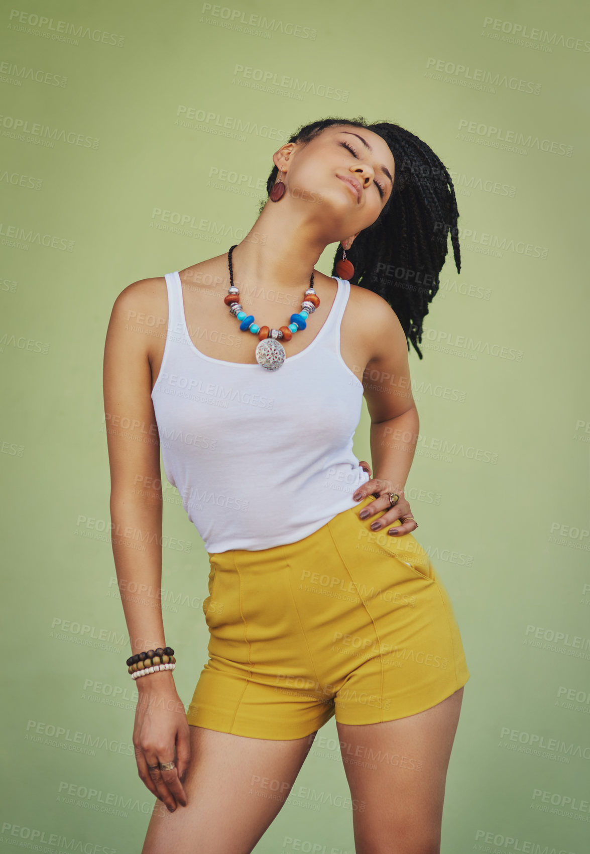 Buy stock photo Young black woman, fashion and style with jewelry, trendy and colorful necklace with confident pose against green studio background. African model with cosmetic jewellery and stylish mock up.