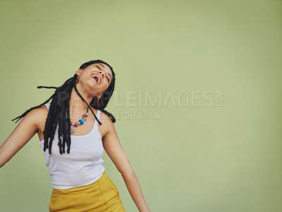 Buy stock photo Shot of an attractive young woman feeling free against a green background