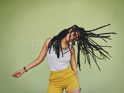 Buy stock photo Shot of an attractive young woman dancing against a green background