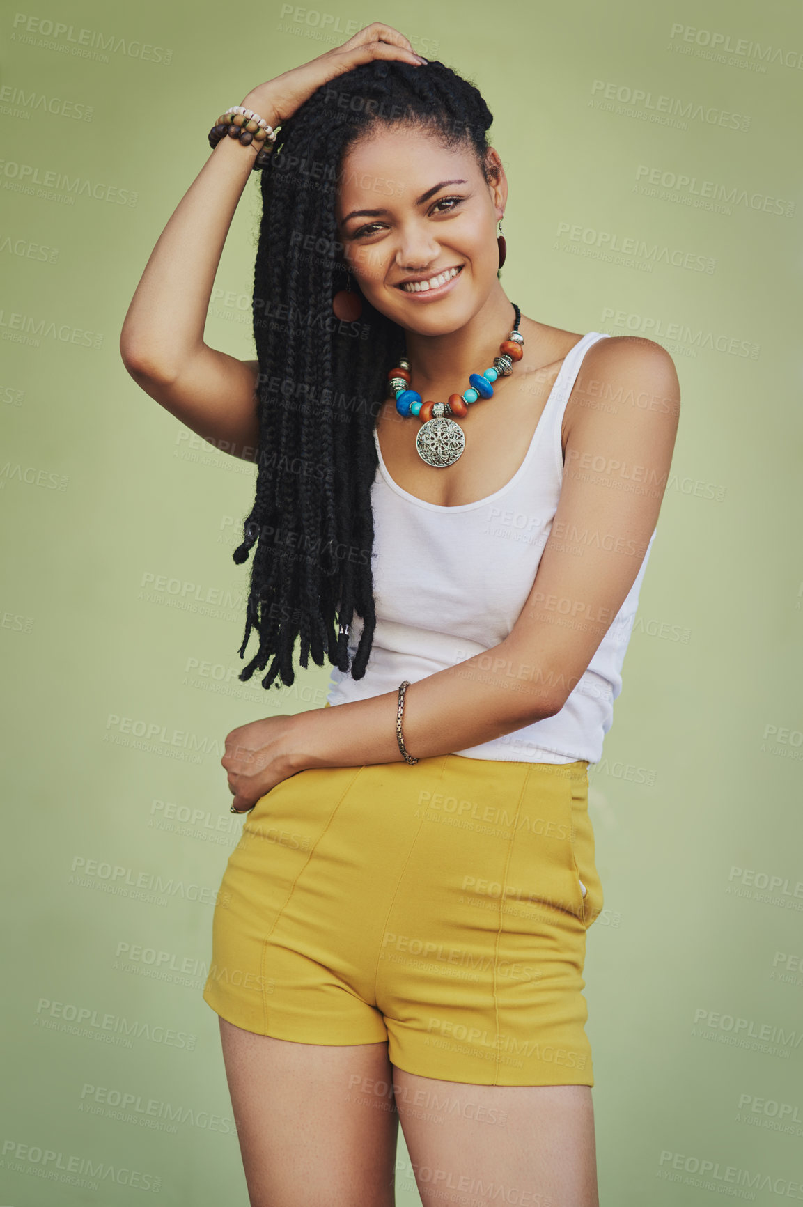Buy stock photo Portrait of an attractive young woman posing against a green background