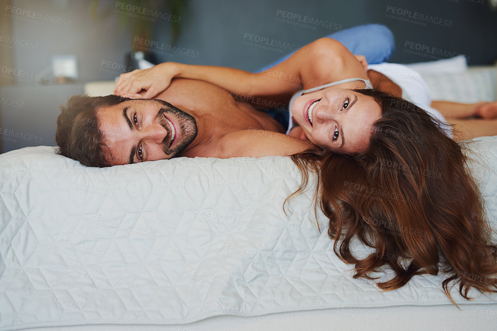 Buy stock photo Portrait, happy and couple relax on bed at house with love, playful game and bonding embrace of marriage romance. Smile, woman and man in bedroom with care, loyalty and relationship commitment