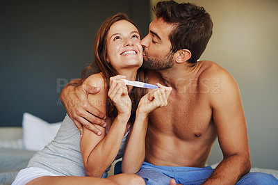 Buy stock photo Shot of a young couple looking at the results on a pregnancy test