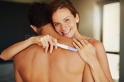 Buy stock photo Portrait of a happy young woman hugging her boyfriend while holding a pregnancy test