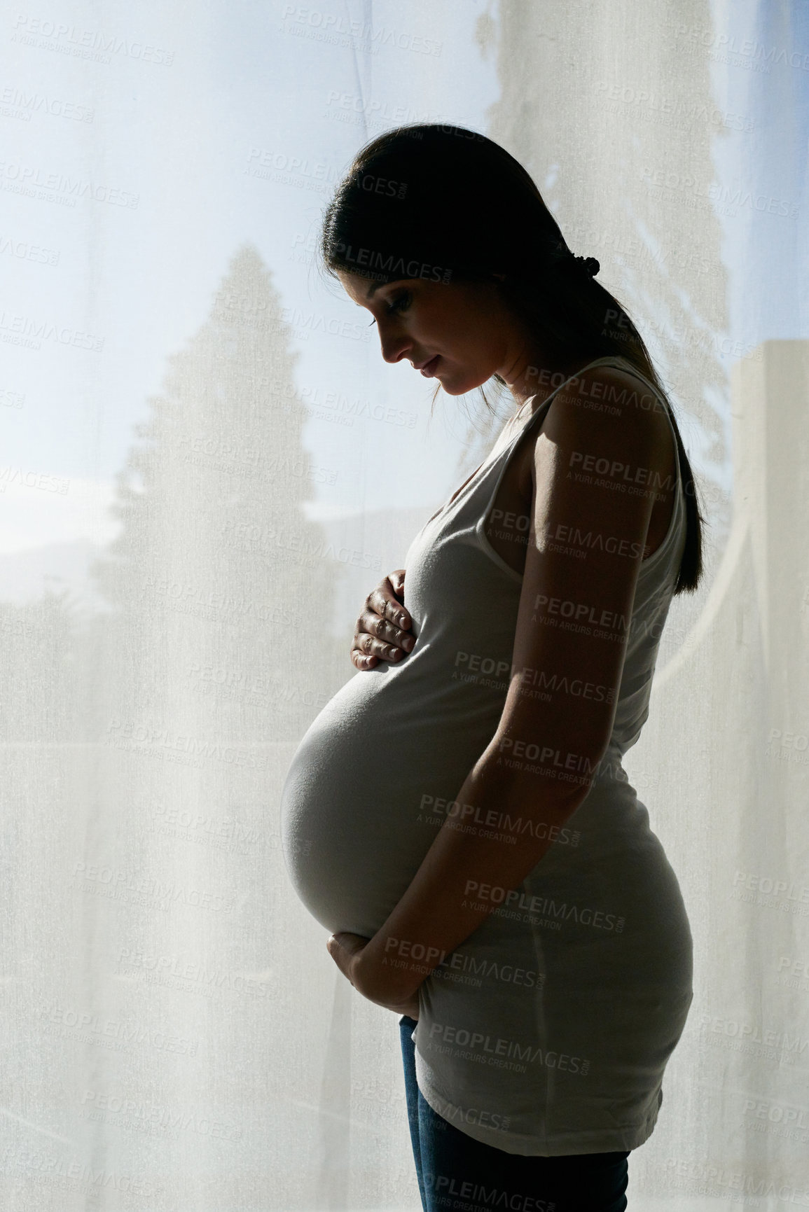 Buy stock photo Pregnant, family and woman by window in home hold stomach for love, prenatal care and support in morning. Happy, pregnancy and person hug tummy for wellness, baby health and maternity in living room