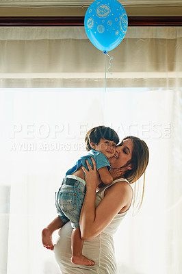 Buy stock photo Shot of a pregnant woman playing with her little boy in her bedroom at home