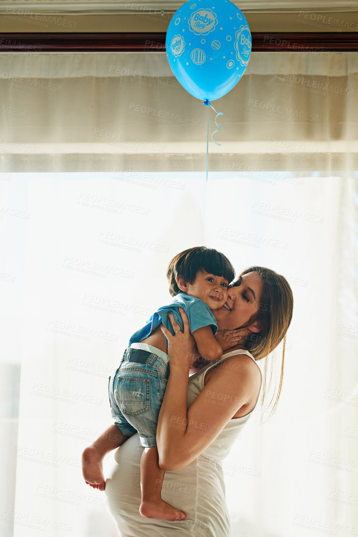 Buy stock photo Shot of a pregnant woman playing with her little boy in her bedroom at home