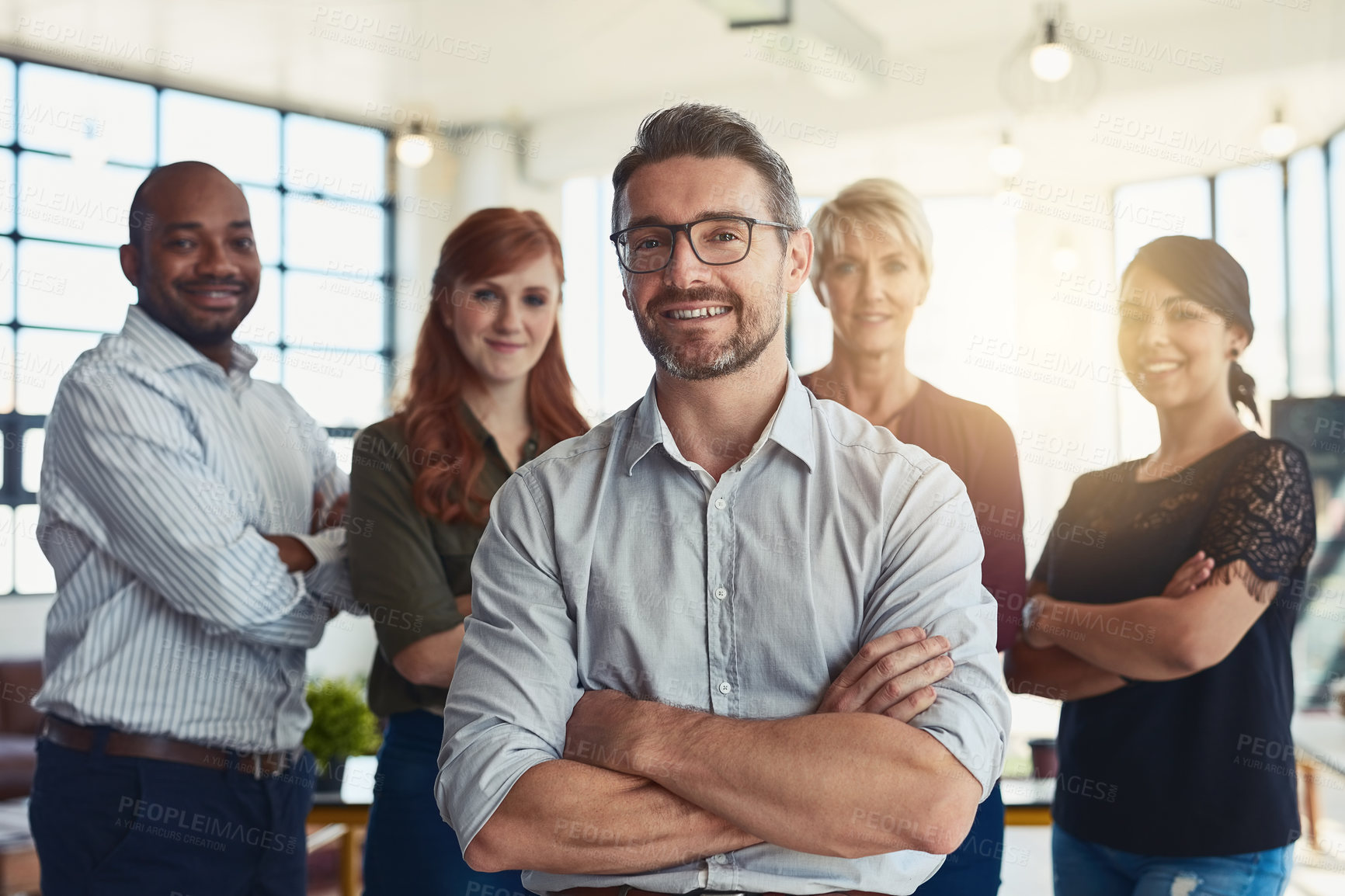 Buy stock photo Happy businessman, portrait and arms crossed in leadership, management or CEO team at the office. Confident business people or professional standing with smile for teamwork or about us at workplace