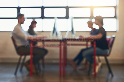 Buy stock photo Blurred shot of a group of designers working on computers in an office
