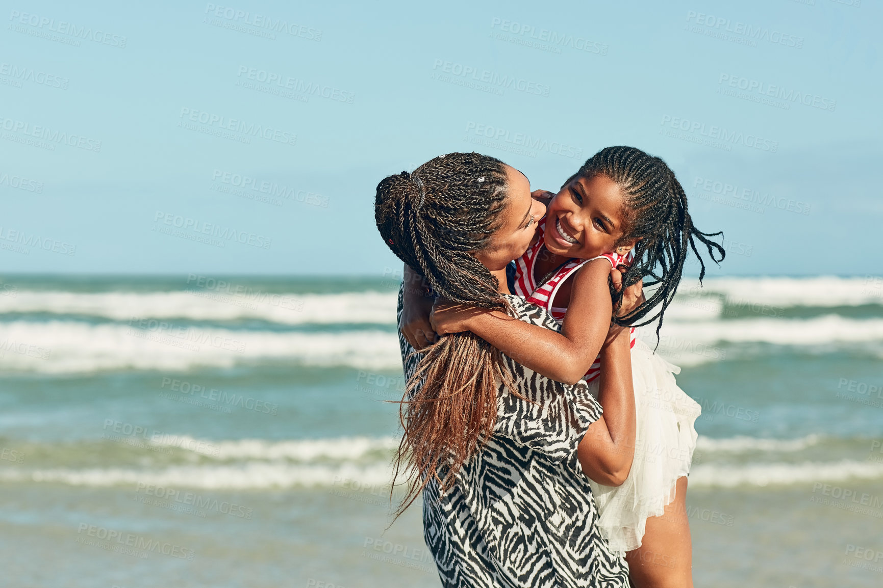 Buy stock photo Shot of a mother and her little daughter enjoying some quality time together at the beach