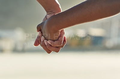 Buy stock photo Closeup shot of an adult holding a child's hand outside