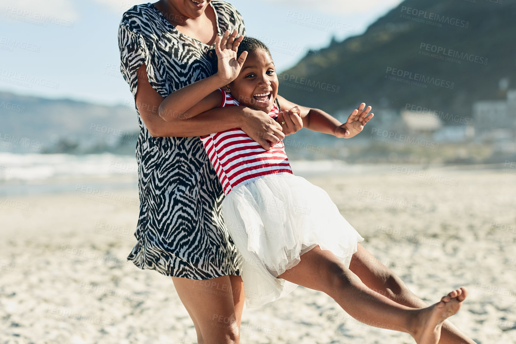Buy stock photo Shot of a mother and her little daughter enjoying some quality time together at the beach