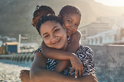 Buy stock photo Portrait of a mother and her little daughter enjoying some quality time together at the beach