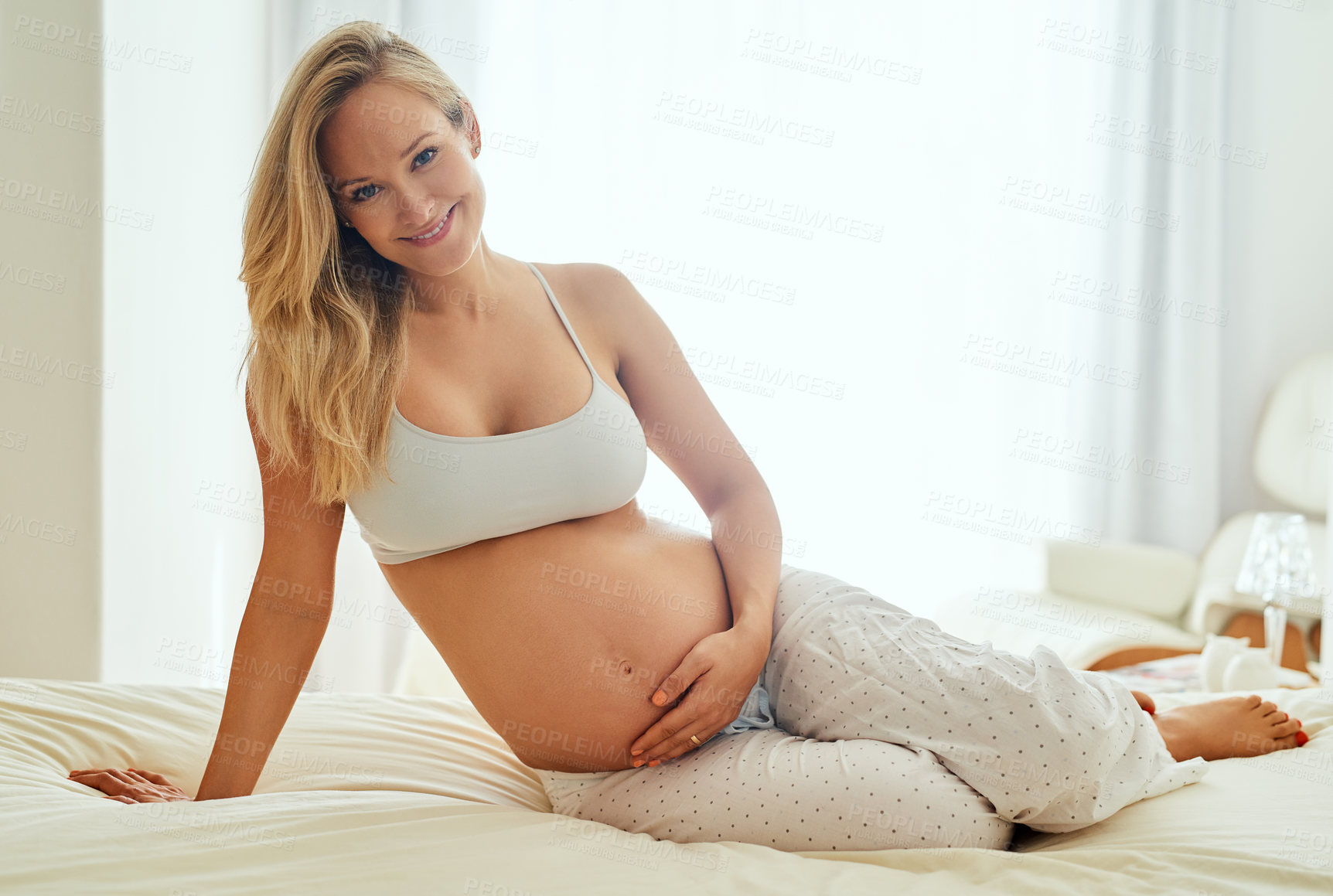 Buy stock photo Love, pregnant and woman with portrait on bed for stomach, prenatal care or relax in bedroom. Smile, pregnancy and future mom with hand on belly for maternal health, happiness or motherhood in home