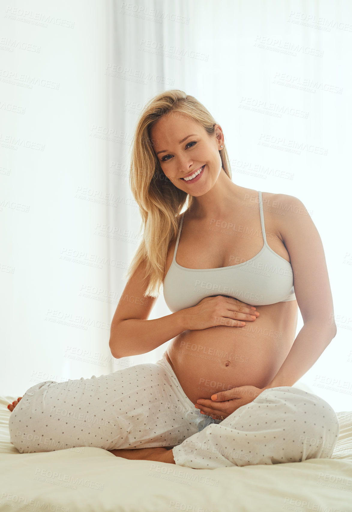 Buy stock photo Portrait, stomach and woman with pregnancy on bed for love, prenatal care or relax in bedroom. Smile, pregnant and future mom with hand on belly for maternal health, happiness or affection in home