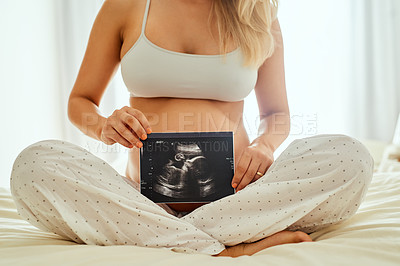 Buy stock photo Hands, pregnant and woman with ultrasound on bed for love, prenatal care or relax in bedroom. Growth, pregnancy and future mom with sonogram for maternal health, happiness or new motherhood in home