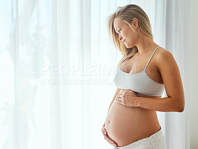 Buy stock photo Shot of a beautiful woman touching her pregnant belly