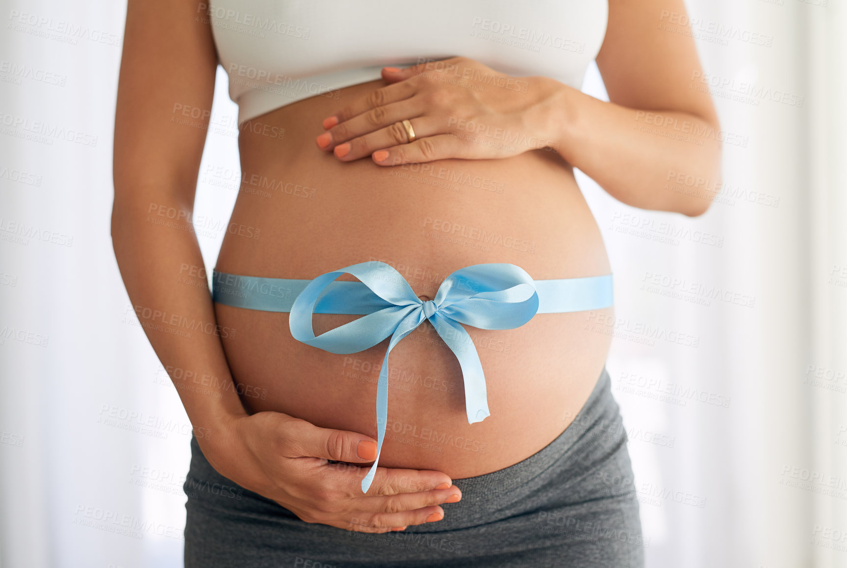 Buy stock photo Stomach, pregnant and woman with blue ribbon in bedroom for gender, boy announcement or gift of fertility. Home, pregnancy and future mom with bow for baby shower, maternal health or hands on belly