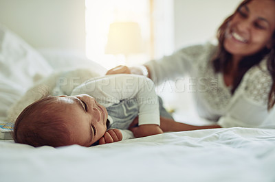 Buy stock photo Shot of a mother and her adorable baby boy bonding at home