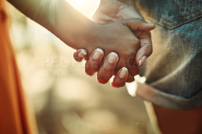 Buy stock photo Closeup shot of an adult holding a child's hand outside