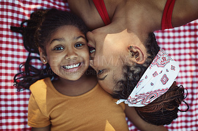 Buy stock photo High angle shot of a mother giving her little daughter a kiss on the cheek