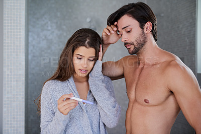 Buy stock photo Couple, pregnancy test and nervous for result in home, maternity kit and wait for outcome in bathroom. People, together and support to check for baby or child, scared and stress for fertility stick