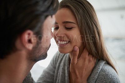 Buy stock photo Shot of an affectionate couple bonding at home