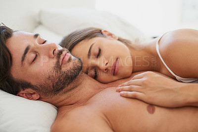 Buy stock photo Shot of a young couple sleeping comfortably in bed
