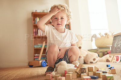 Buy stock photo Portrait of an adorable little boy playing with wooden blocks at home