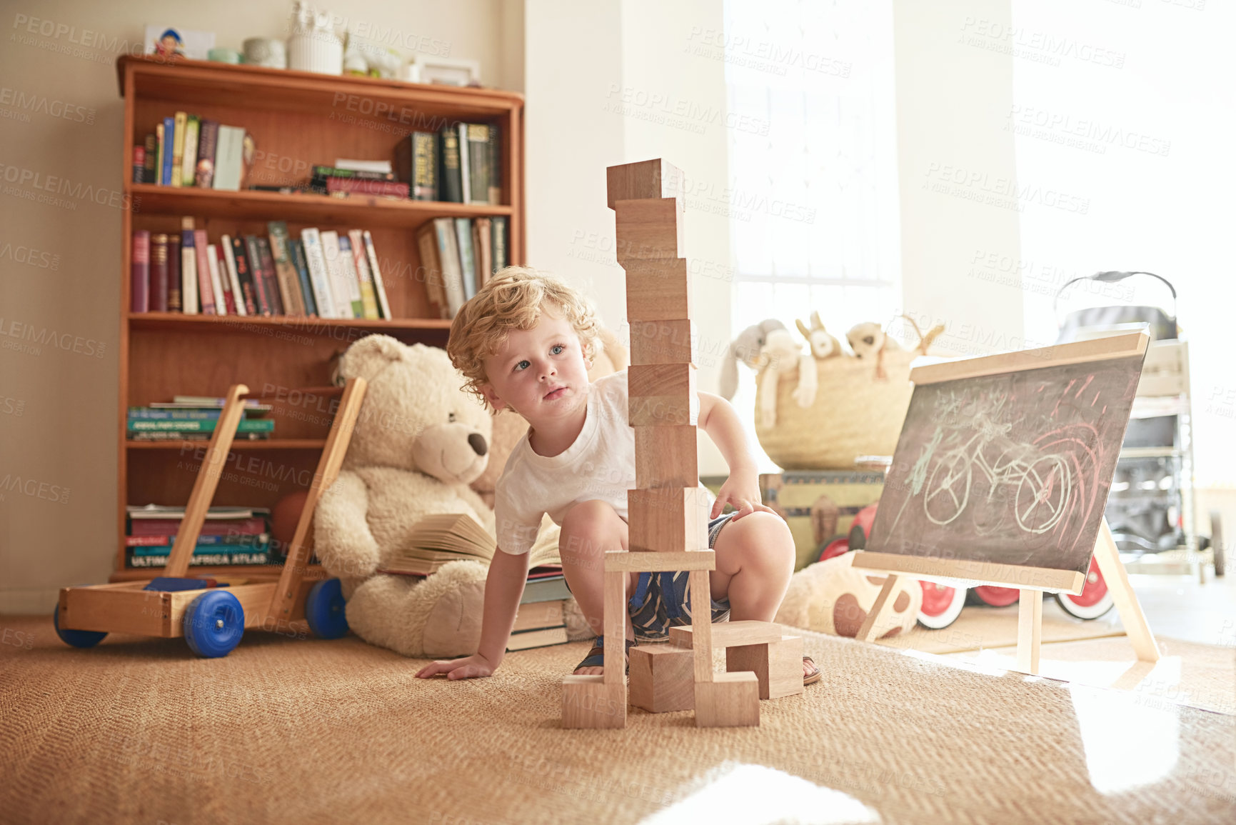 Buy stock photo Child, playing and wooden blocks for education at house by creative learning, building game or motor development. Boy, carpet and childhood with puzzle, construction play or fantasy activity on floor