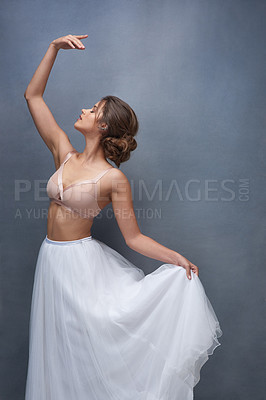 Buy stock photo Portrait of a beautiful young woman posing in studio while wearing a bra and ballet skirt