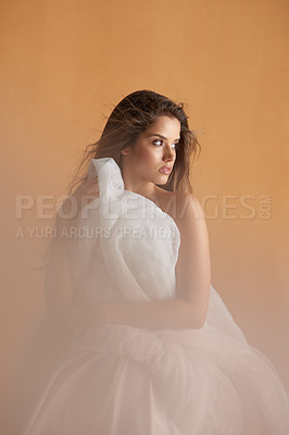 Buy stock photo Portrait of a beautiful young woman covering herself with a ballet skirt in studio