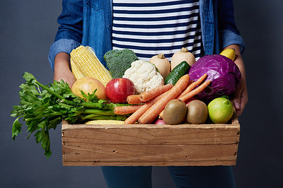 Buy stock photo Studio, box and hands of person with vegetables, nutrition and fresh fruits in basket. Small business, organic and harvest with farmer or supplier, agriculture and healthy food by gray background