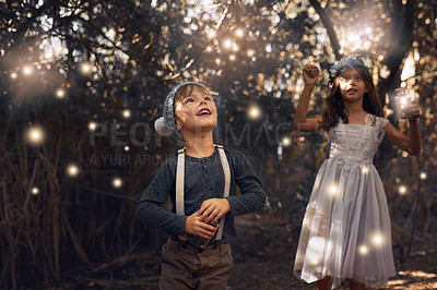 Buy stock photo Shot of two little siblings catching fireflies in jars outside