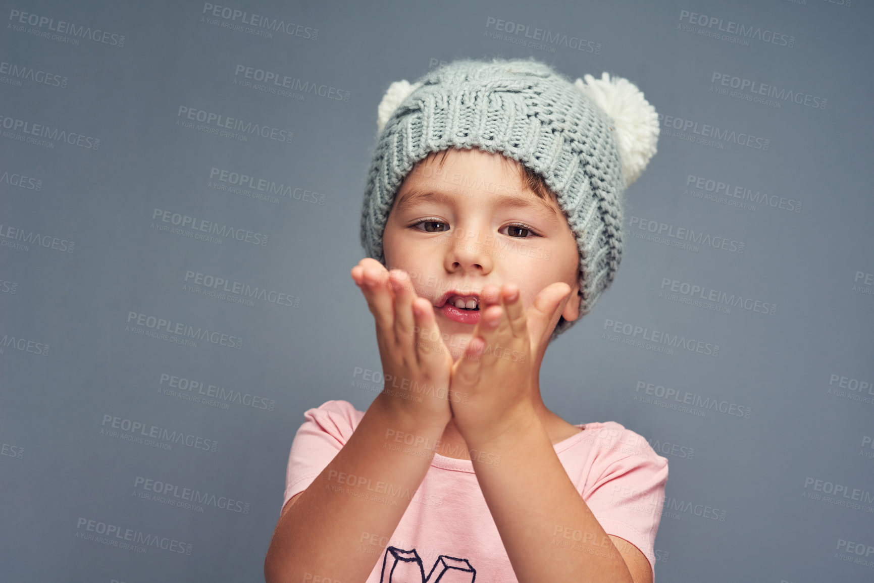 Buy stock photo Happy boy, portrait and blowing kiss with fashion, style or clothing on gray studio background. Little child, kid or youth with love, beanie or winter cap in care, gratitude or childhood on space