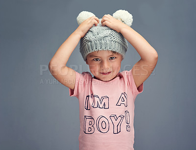 Buy stock photo Studio portrait of a boy wearing a t shirt with “I’m a boy” printed on it against a gray background