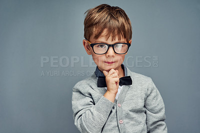 Buy stock photo Fashion, glasses and portrait of clever boy in studio isolated on blue background for intelligence. Bowtie, genius and style with face of geek or nerd kid in trendy outfit for child development