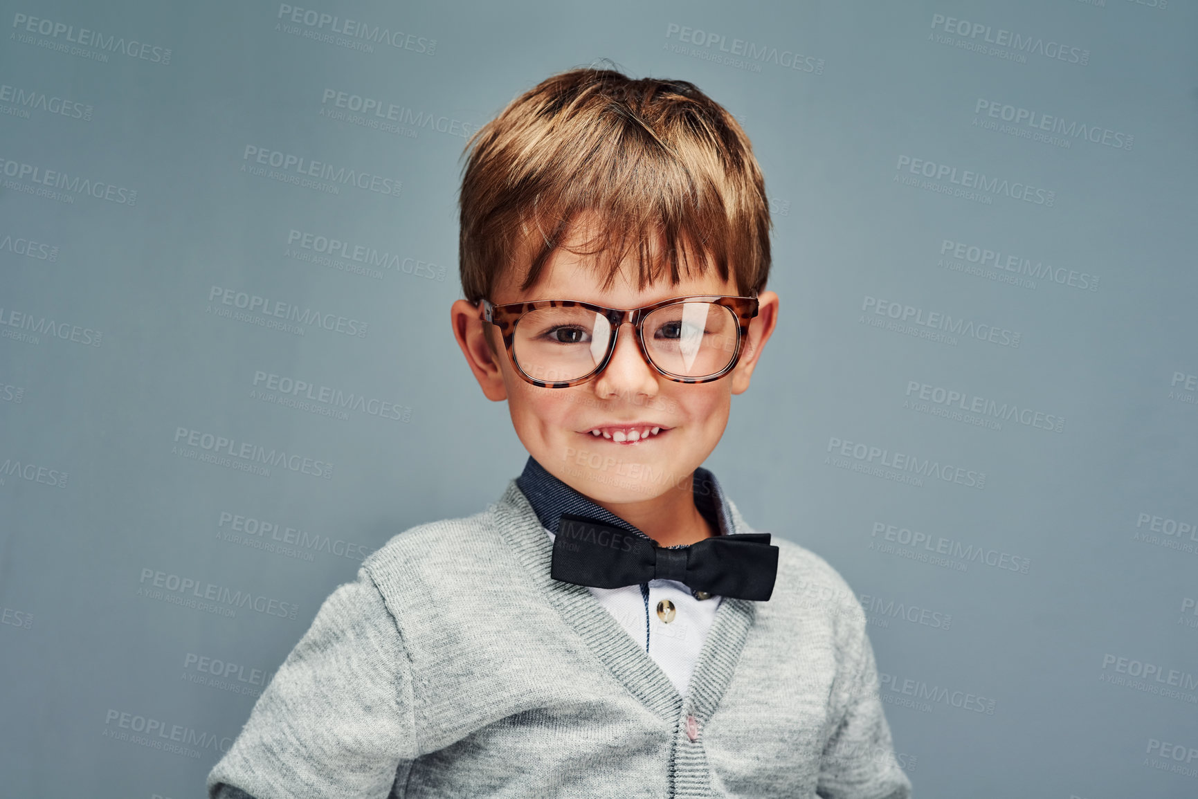 Buy stock photo Studio portrait of an adorable little boy dressed smartly against a gray background