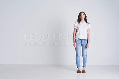 Buy stock photo Studio shot of a beautiful young woman standing against a grey background