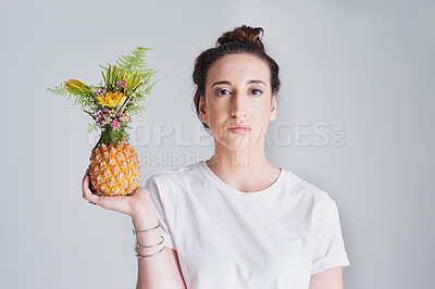 Buy stock photo Studio shot of  a beautiful young woman holding a pineapple against a grey background