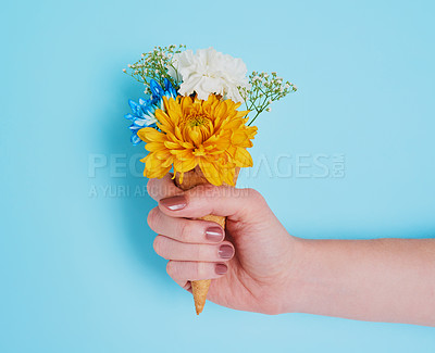 Buy stock photo Cropped shot of an unrecognizable woman holding a cone stuffed with flowers