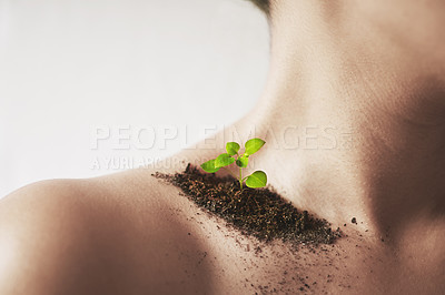 Buy stock photo Shot of an unidentifiable young woman's shoulder with soil and a small seedling on it