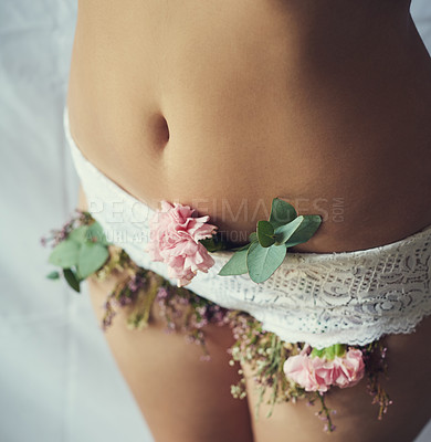 Buy stock photo High angle shot of an unidentifiable young woman with flowers growing out of her lace panties
