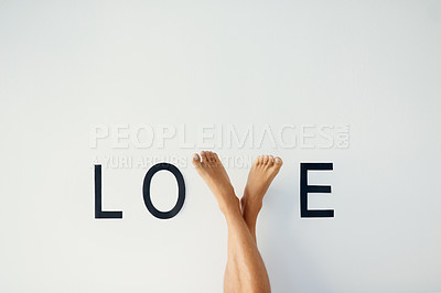 Buy stock photo  Love, word and feet of model with care, happiness and romance sign of emotion gesture. Text, gratitude and legs of person for expression of connection, commitment or devotion by white background.