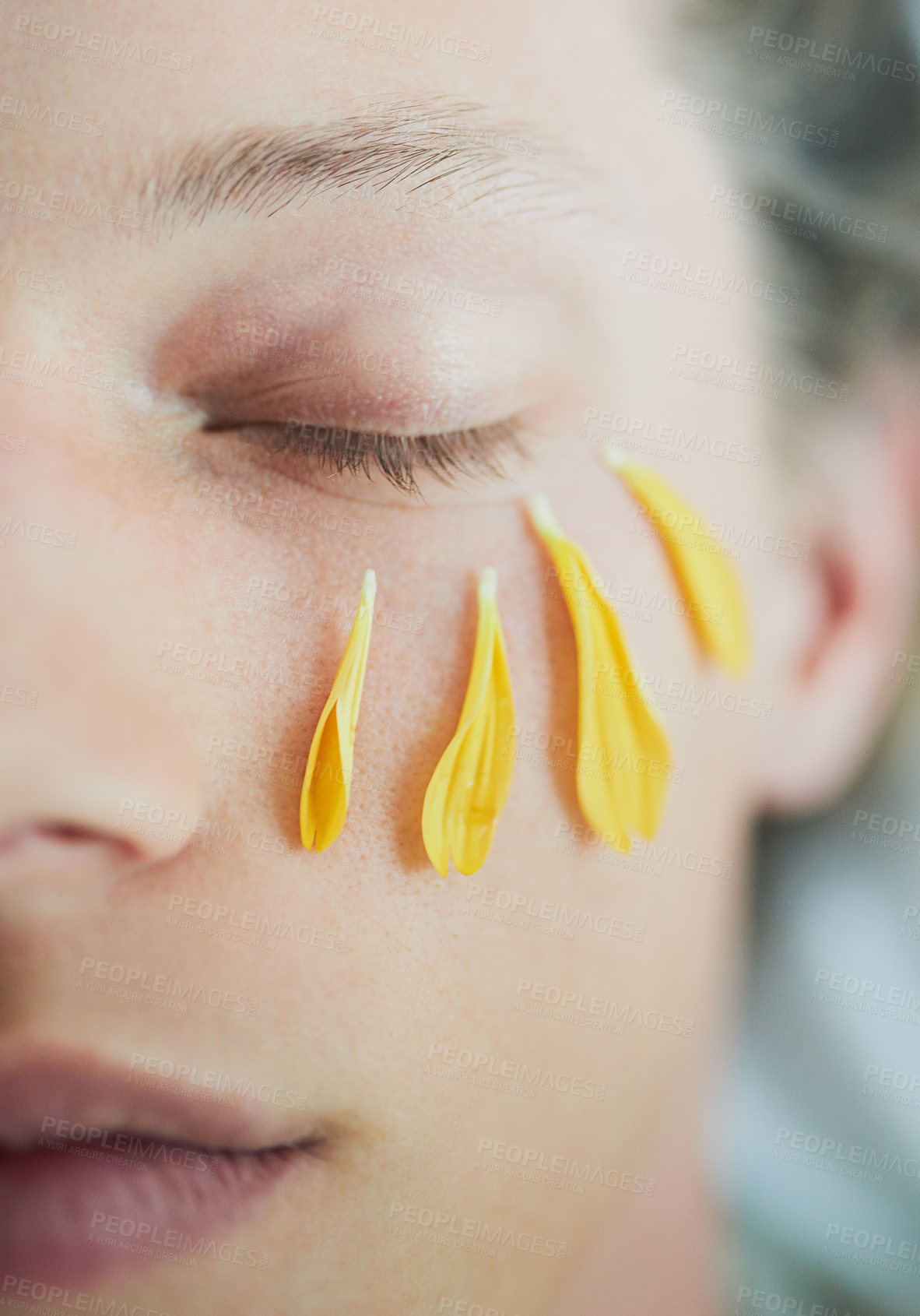 Buy stock photo Cropped shot of a young man's face with flower petals under his eye with his eyes closed