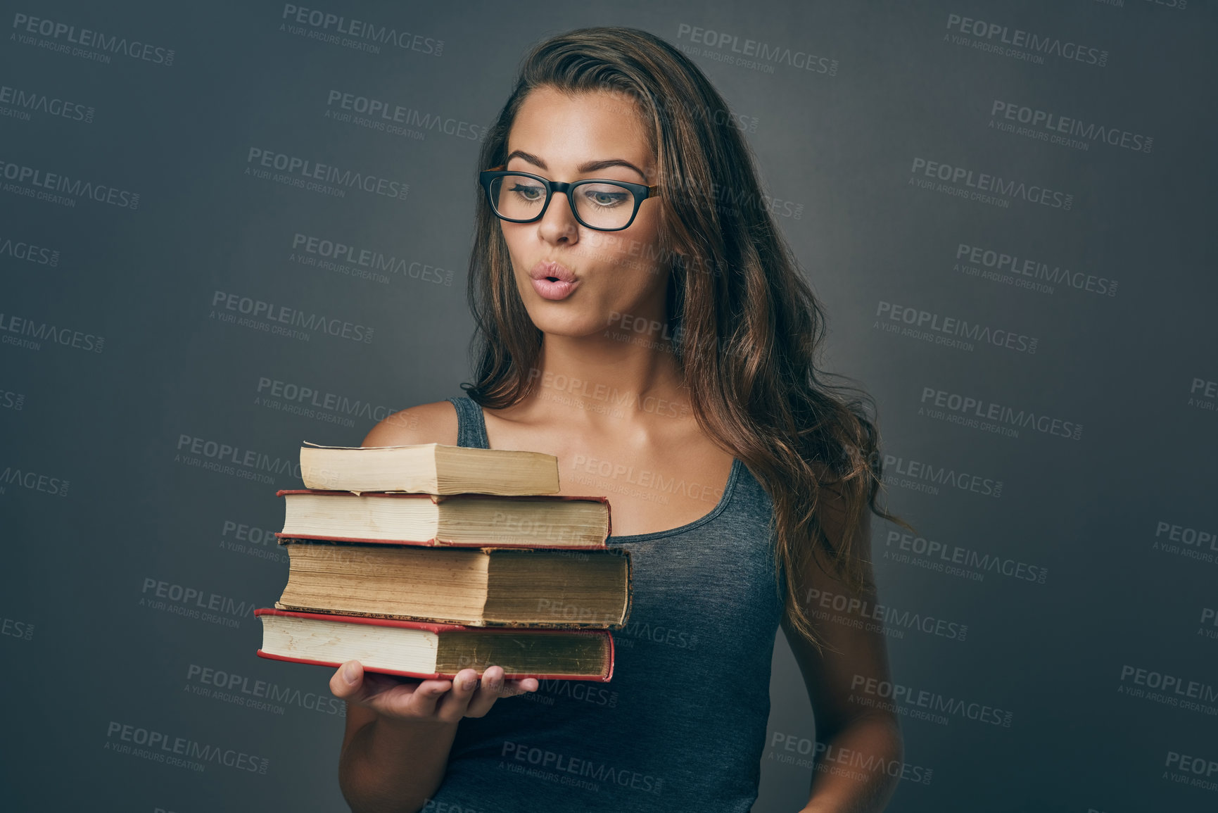 Buy stock photo Happy, surprise and books with woman with university, college and library study textbook in studio. Wow, knowledge and school learning wonder of student with education, exam and dark background