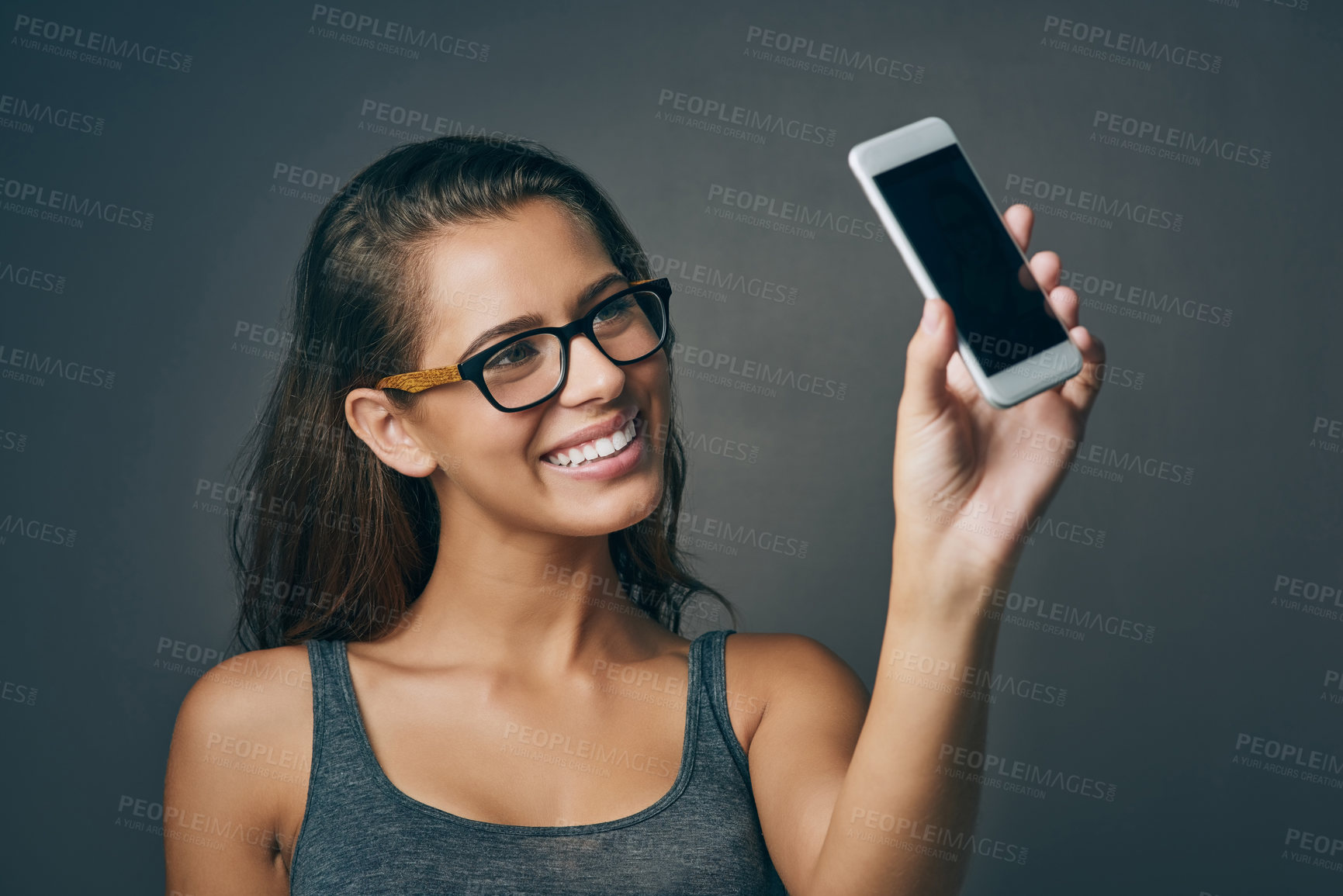 Buy stock photo Woman, studio and happy with eyeglasses on selfie on grey background for eyesight and eyewear prescription. Female person, smile and confident with social media post or profile picture with frame