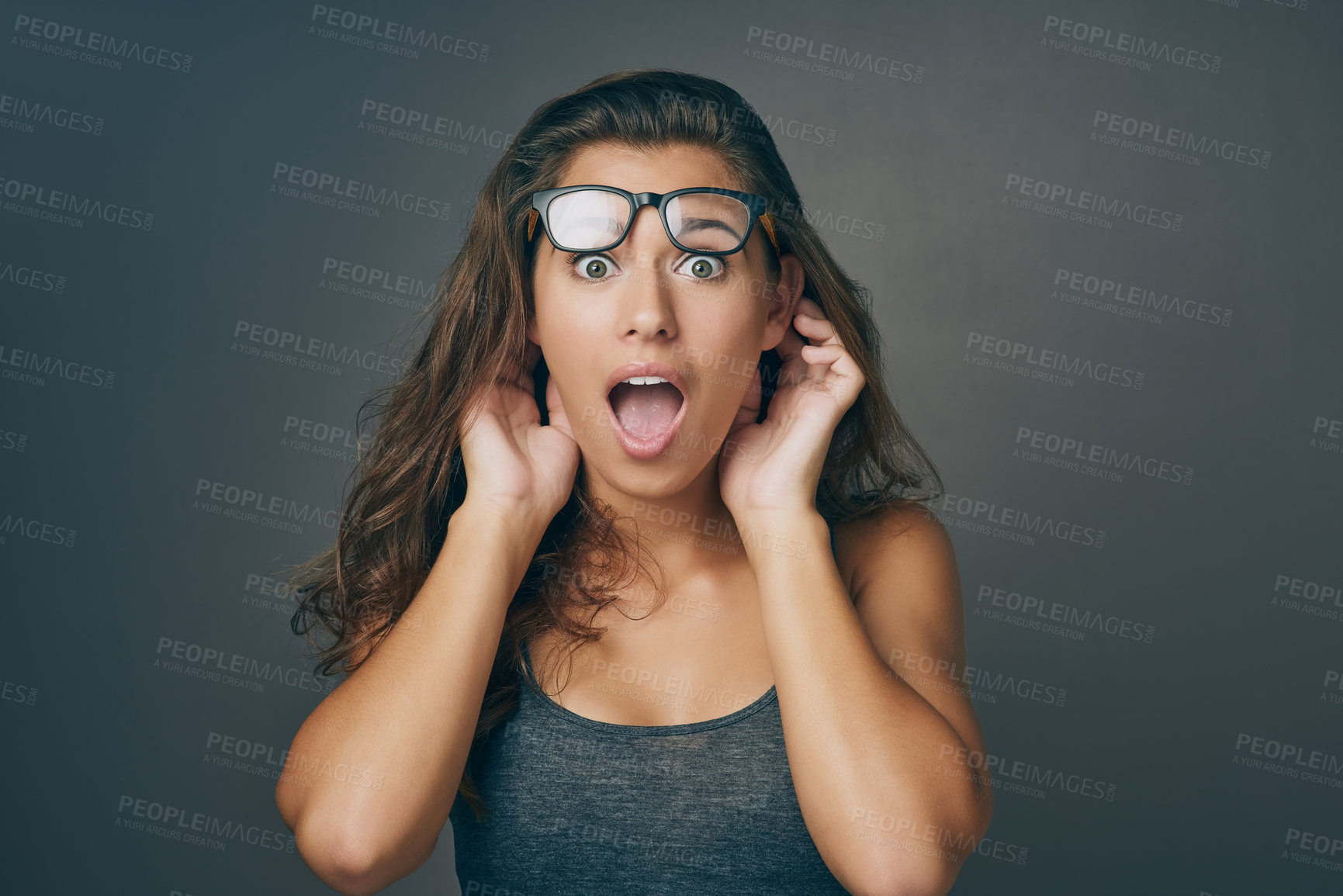 Buy stock photo Woman, portrait and surprise with glasses in shock for news, alert or notification on a gray studio background. Face of young female person or model expression in disbelief or wow for rumor or gossip