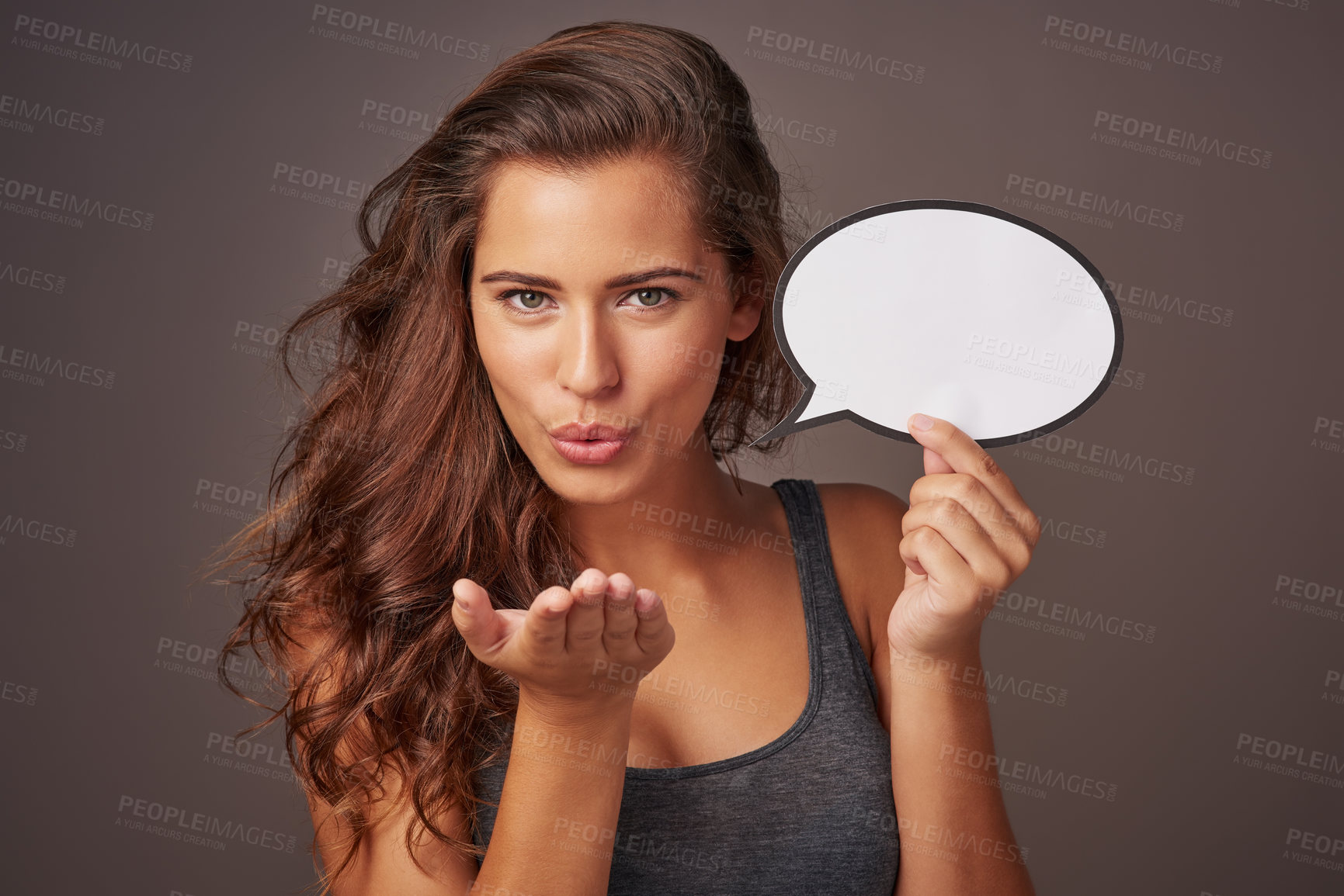 Buy stock photo Speech bubble, blow kiss and portrait of woman in studio for news, flirting and love gesture. Mockup space, social media and person with sign for information, announcement or emoji on dark background